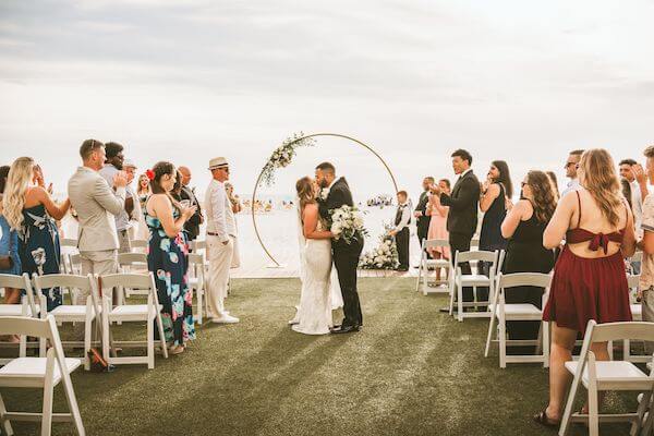 bride and groom kissing after their beach wedding ceremony