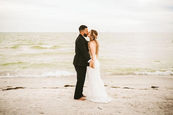 bride and groom posing for photos on Clearwater Beach