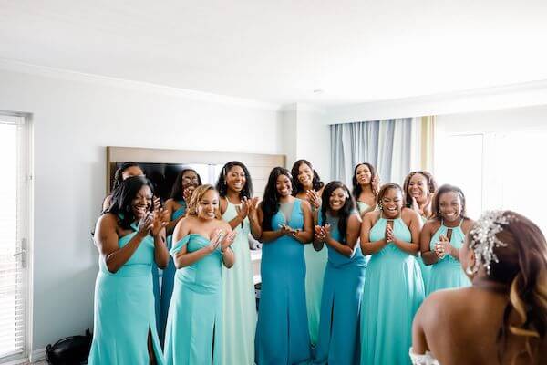 bridal party in amazing ocean blue ombre toned dresses seeing the bride for the first time