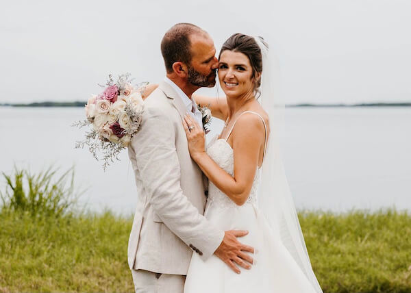 bride and groom on the waterfront after their wedding at Tampa Bay Watch