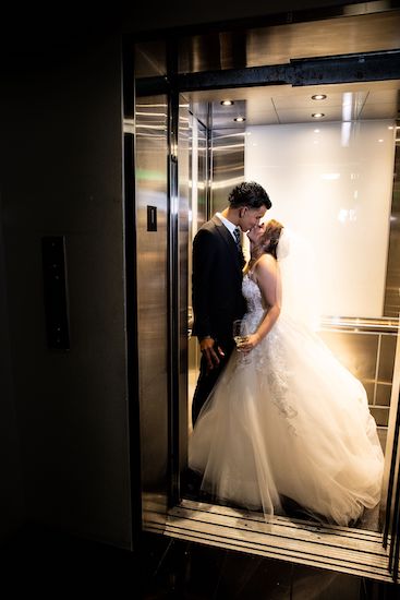 bride and groom kissing in the elevator of the Le Meridien Hotel Tampa