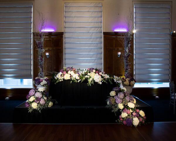 A sweetheart table in black, silver, and purple for a halloween wedding