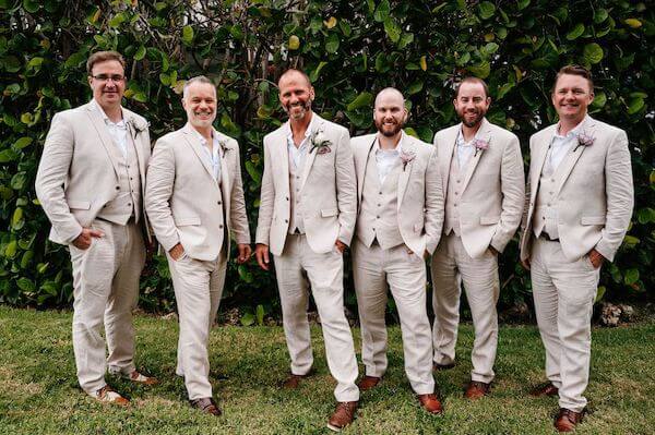 groom and groomsmen in sand colored suits at Tampa Bay Watch