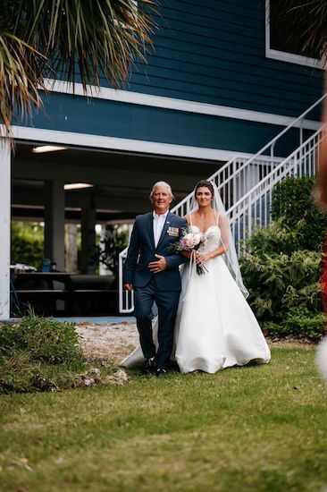 Father of the bride walking his daughter down the aisle at Tampa Bay Watch