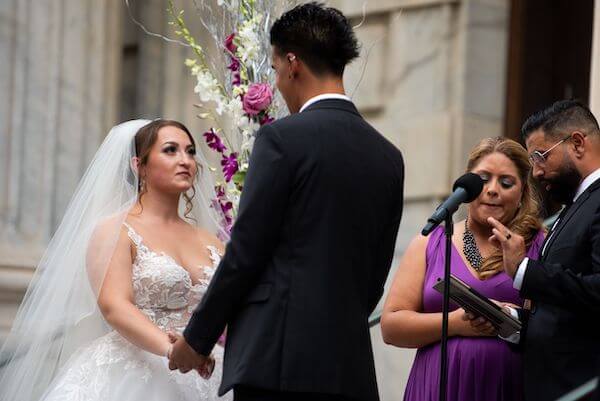 bride and groom exchanging wedding vows at their Tampa  halloween wedding