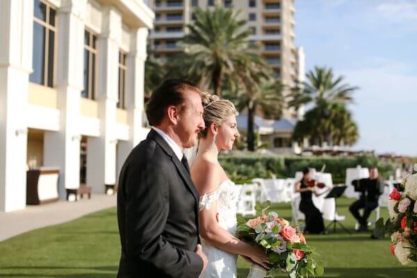 string quartet playing as a bride and her father walk down the aisle 