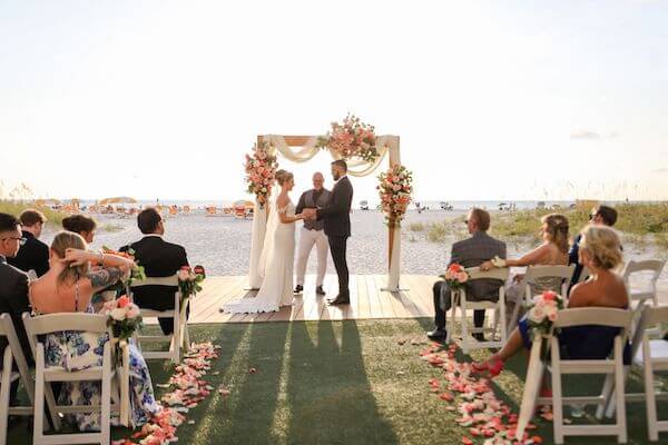 bride and groom exchaning wedding vows during their beachside wedding ceremony