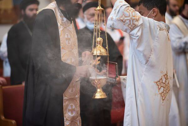 priests lighting insence during a Tampa Bay Coptic  Orthodox wedding ceremony