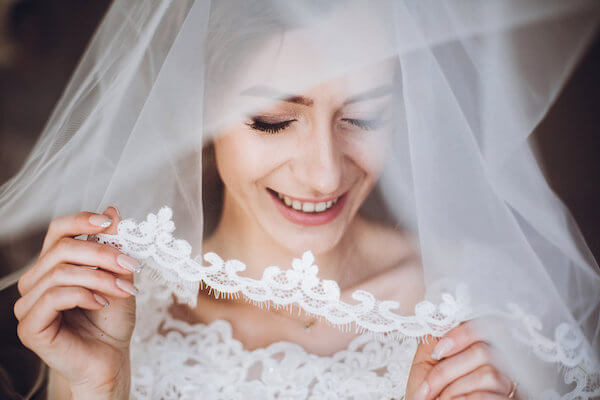 bride lifting her wedding veil