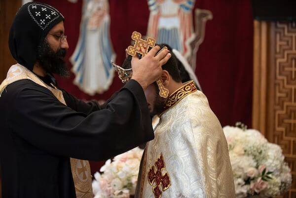 Groom being crowned during his Tampa Bay Coptic wedding ceremony