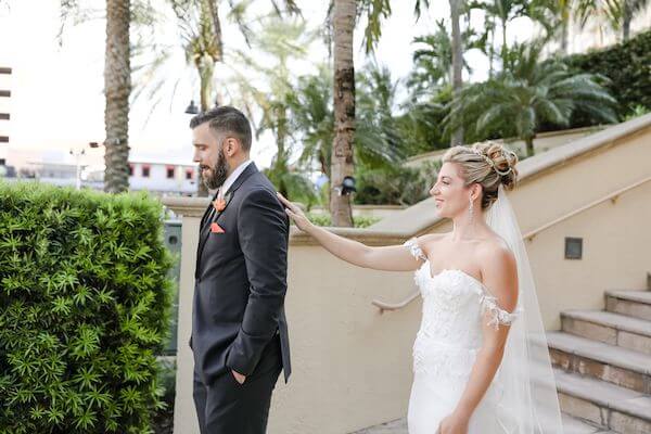 bride waking up behind her groom for their first look