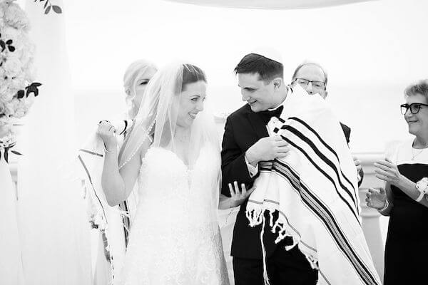 Bride and groom under a chuppah during their Clearwater beach Jewish wedding