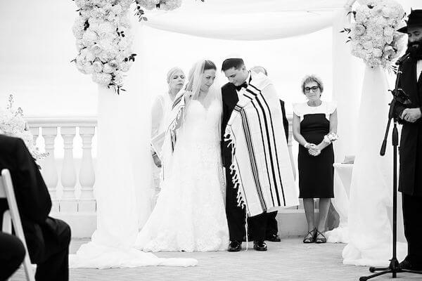 Bride and groom under a chuppah during their Clearwater beach Jewish wedding