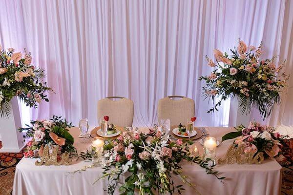 Sweetheart table set with pink, white, Champagne and starfish