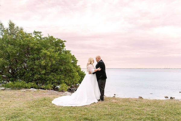 Bride and groom at sunset before their wedding reception at The Rusty Pelican in Tampa