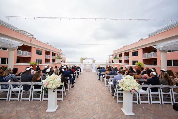 Wedding guests gathered on the Hyatt Clearwater Beach's Sky Terrace for a Jewish wedding ceremony