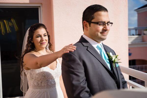 bride tapping her groom on the shoulder during thier first look