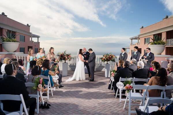 bride and groom exchanging wedding vows on the rooftop of the Hyatt Clearwater Beach