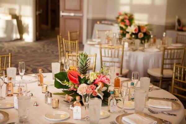 Ballroom of the Hyatt Clearwater Beach decorated in gold with bright tropical flowers