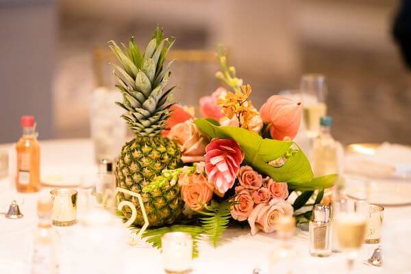 bright tropical flowers and fresh fruit created a tablescaper for a Clearwater Beach wedding