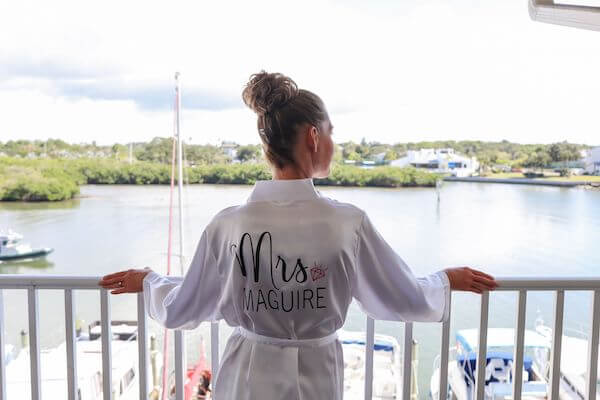 Bride looking over the gulf of mexico while she gets ready for her wedding