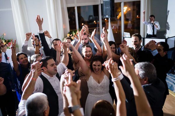 bride and groom celebrating with family and friends for thier last dance