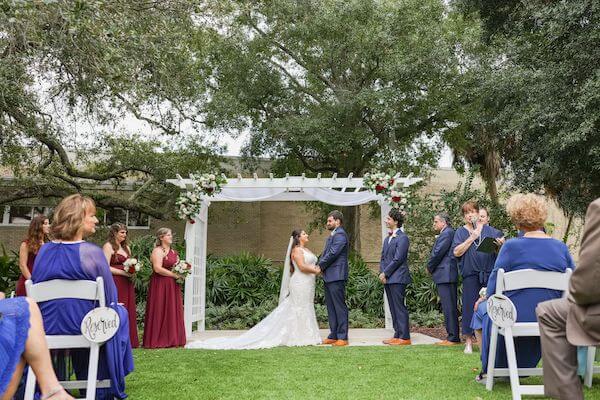 Tampa bride and groom exchanging wedding vows at the Tampa Garden Club