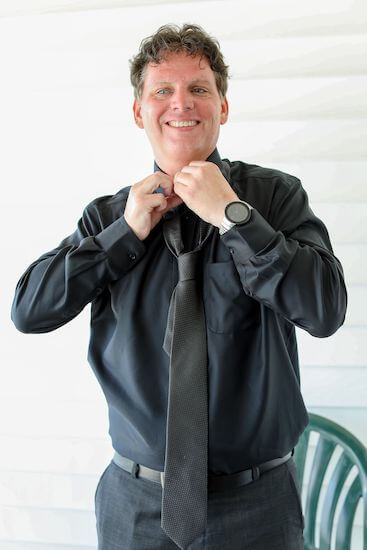 groom fixing his tie