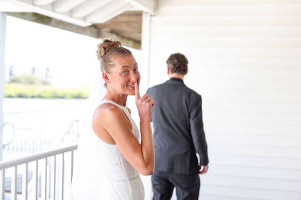 bride sneaking up on her groom for thier first look