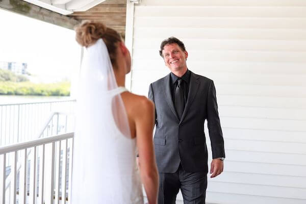 groom smiling seeing his bride to be for the first time