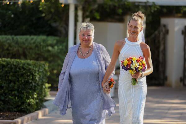 bride being escored down the aisle by her mother