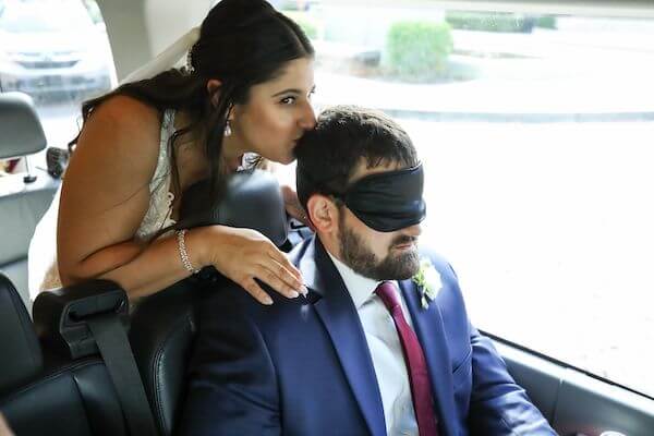 Tampa bride standing behind her blindfloded groom to be as they head off for their first look