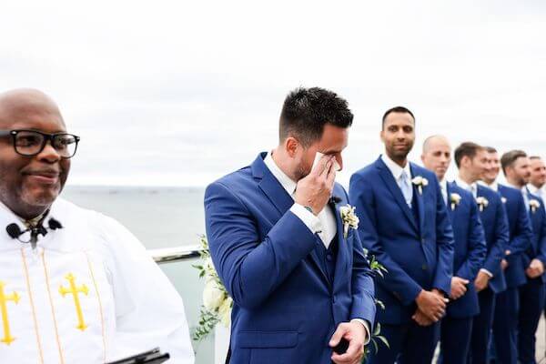 Groom gettin emotional as he sees his bride-to-be walking down the aisle