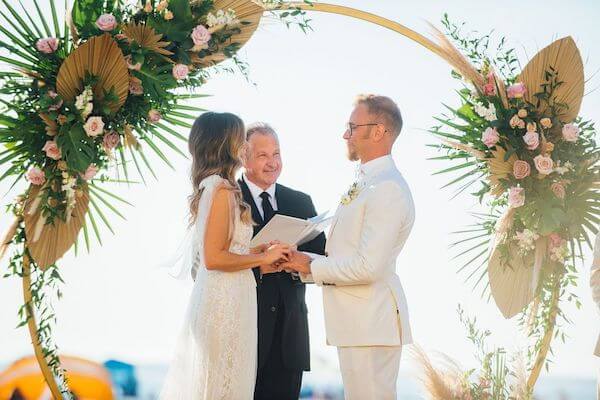 bride and groom exchanging wedding vows on Clearwater Beach