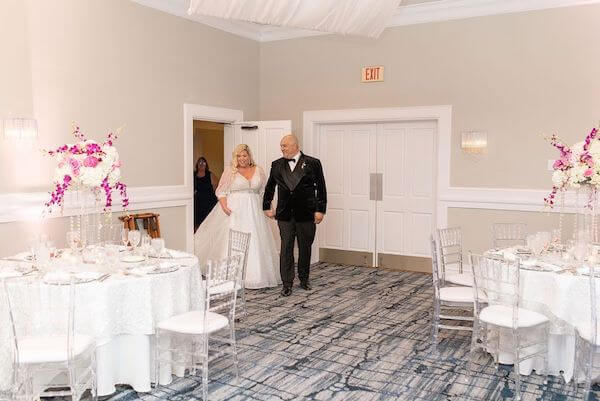 Bride and groom taking a sneak peek at their Tampa wedding reception at the Rusty Pelican