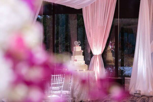 sparkling four tiered wedding cake and ballroom at Rusty Pelican Tampa