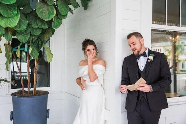 bride and groom having an emotional moment when they can touch but not see each other