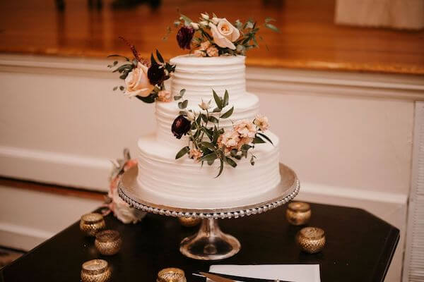 Three tiered white Publix wedding cake with fresh flowers