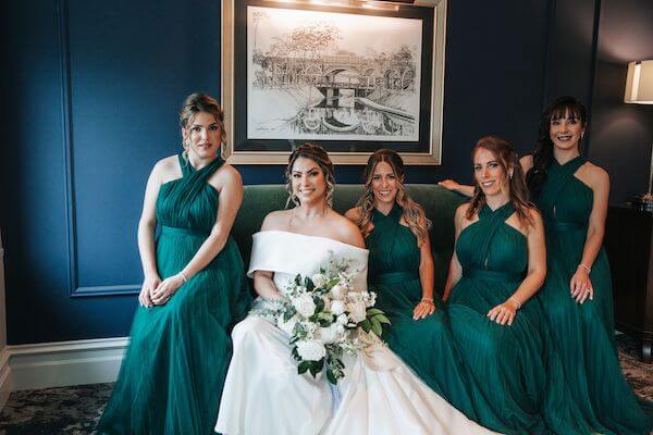 bride with bridal party in hunter green dresses