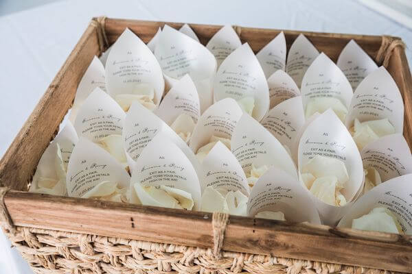 paper cones filled with white rose petals 