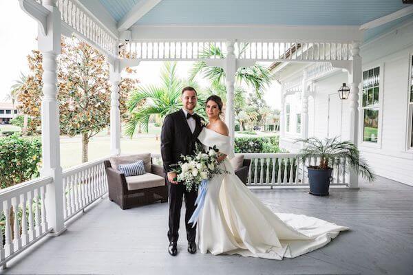 bride and groom on the porch of the Belleview Inn