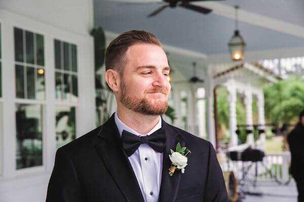 groom looking on as his bride walks down the aisle