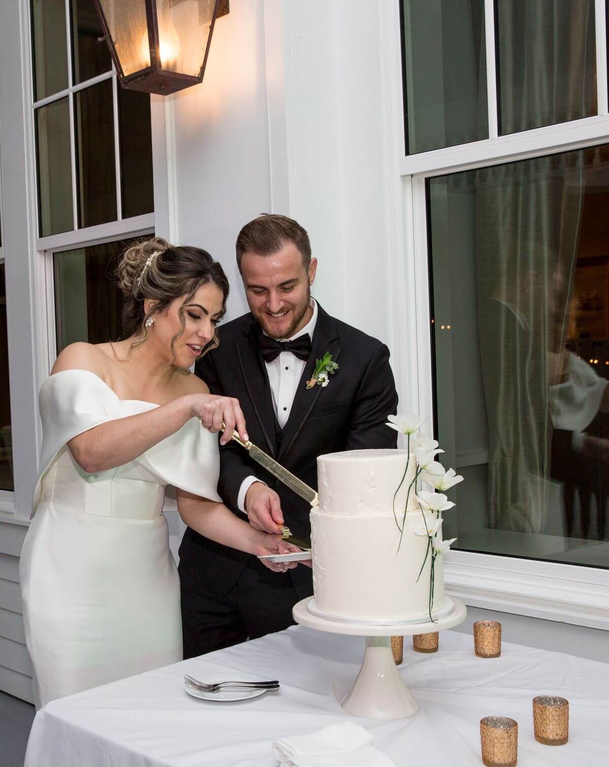 bride and groom cutting a simple intimate wedding cake