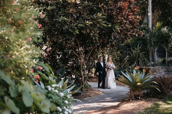 Brid ena Cher father walking down the aisle at Sunken Gardens in St Pete