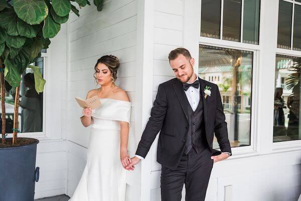 bride and groom having an emotional moment when they can touch but not see each other