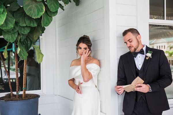 bride and groom having an emotional moment when they can touch but not see each other