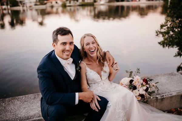 St Pete bride and groom laughing taking wedding portraits