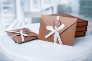 custom wedding invitations with a wax seal and a bow