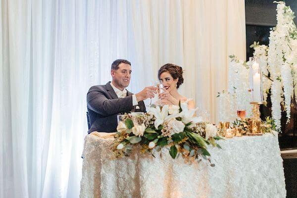 bride and groom toasting at their wedding reception