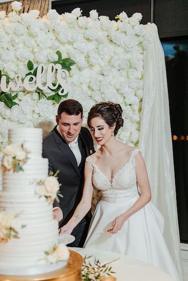 bride and groom cutting thier wedding cake